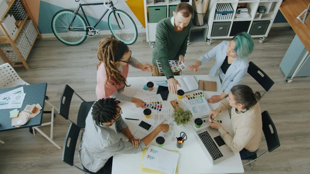 Marketing team planning a campaign around a table