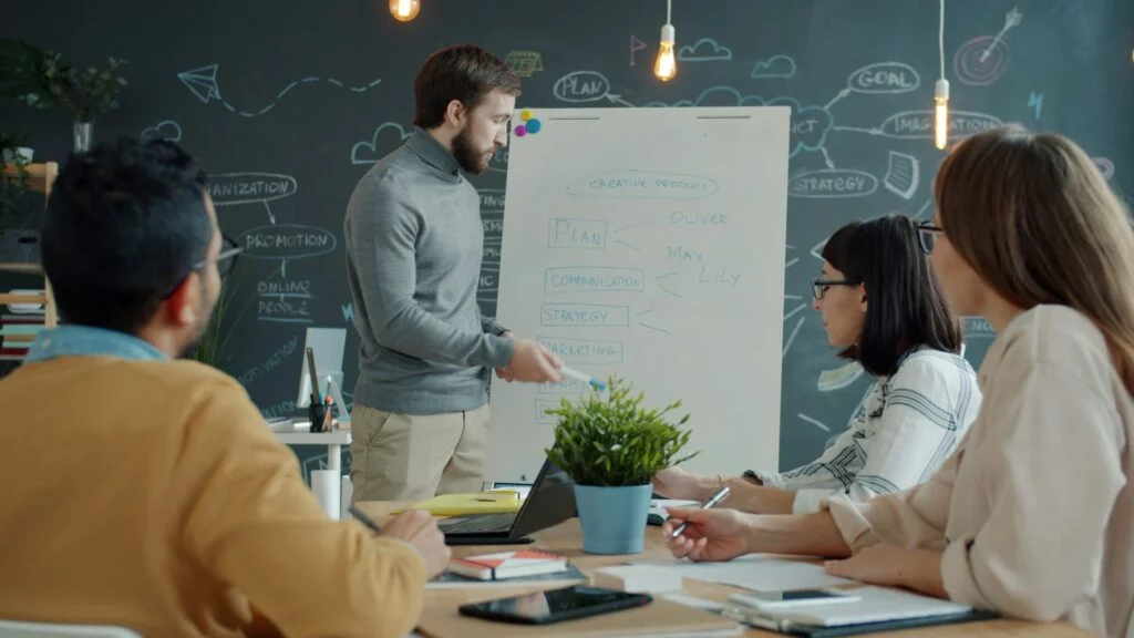 Digital marketing strategy session at a whiteboard